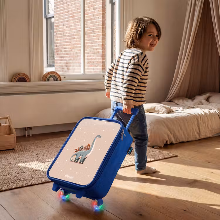 Blauwe dinosaurus op een beige stippenachtergrond Kinderkoffer - Blauw klein -sfeer1